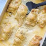 Casserole dish filled with crescent rolls topped with sauce.