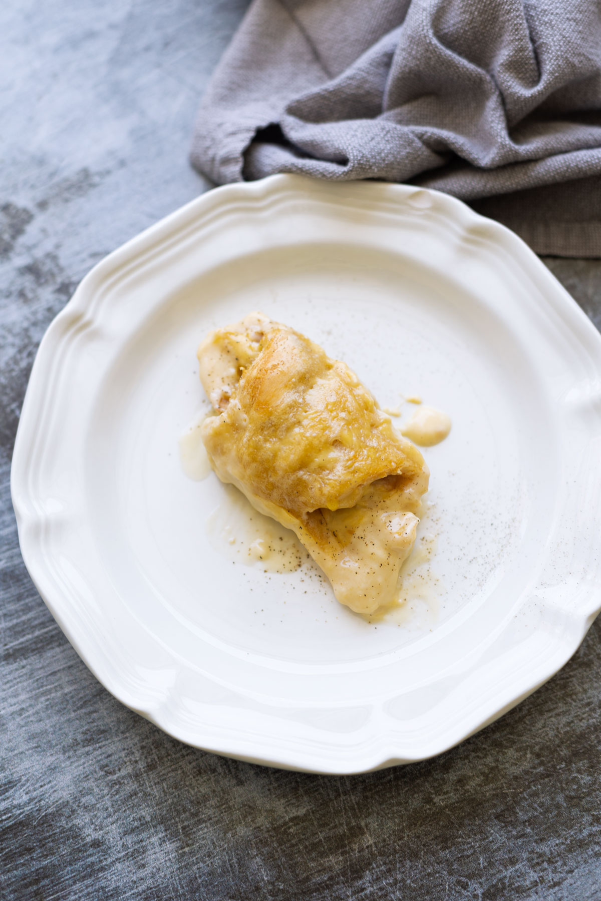 A single chicken crescent roll on a plate. 
