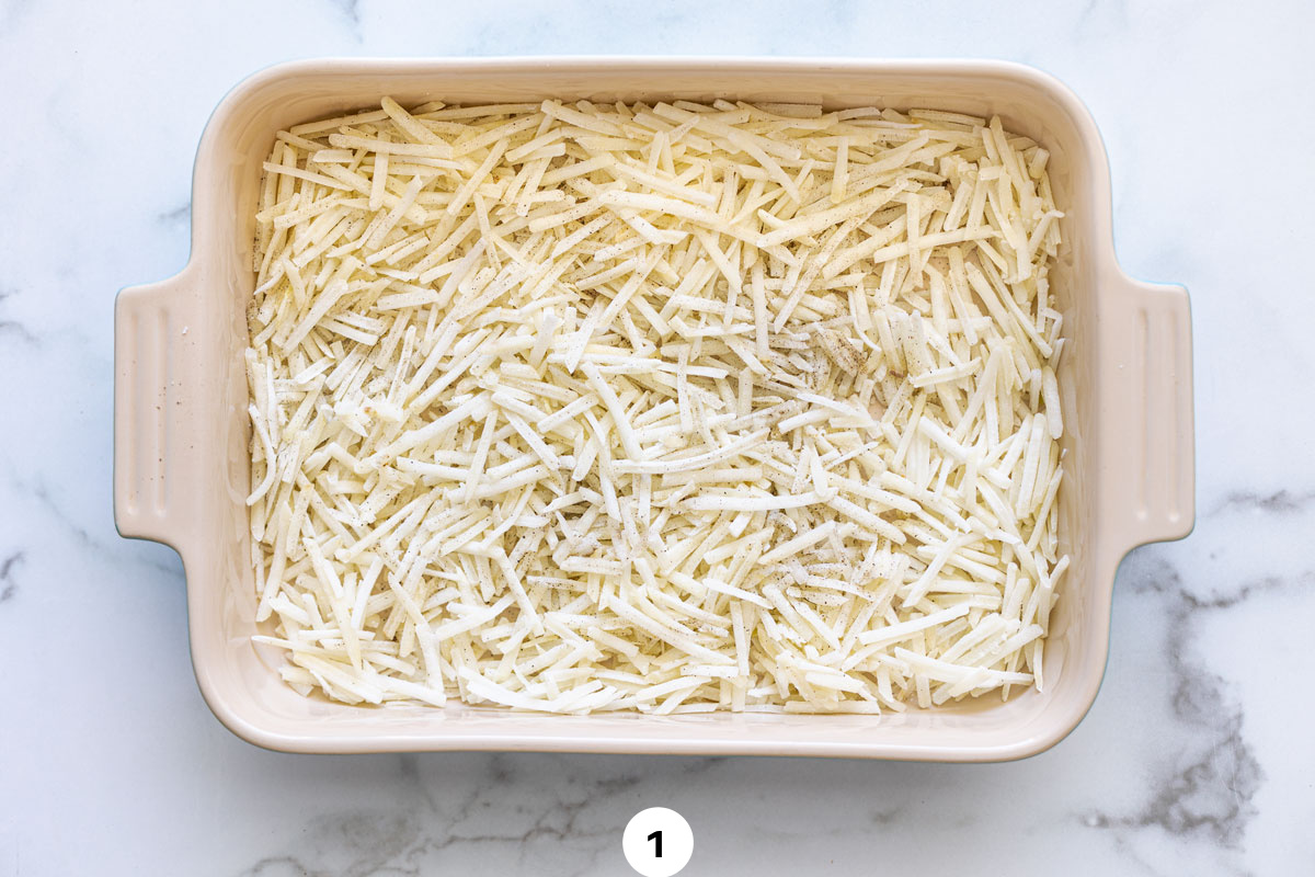 A layer of hash browns in a 9x13 pan. 
