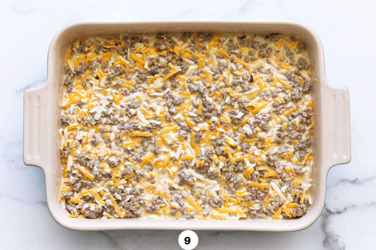 A dish of prepared hash brown breakfast casserole ready to be baked in the oven. 