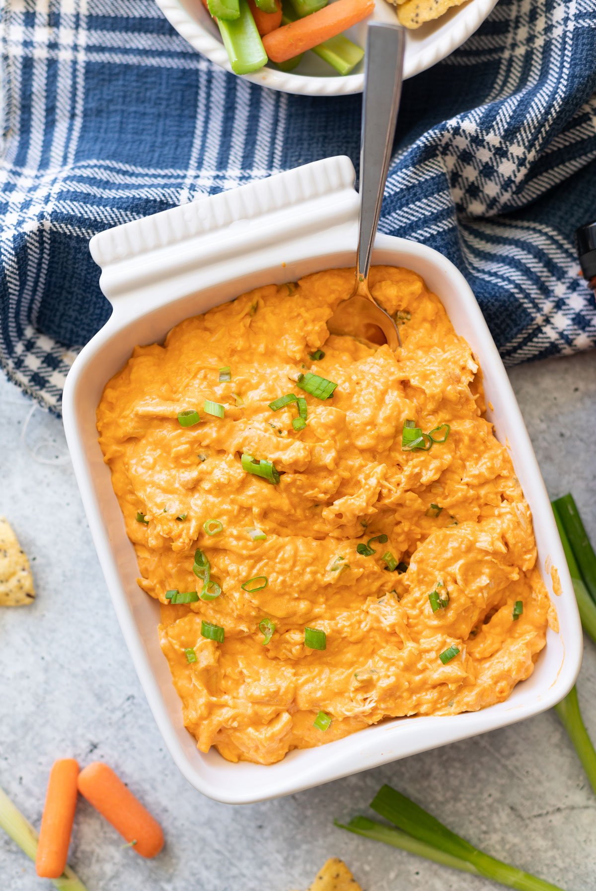 A dish with buffalo chicken dip ready to be served. 