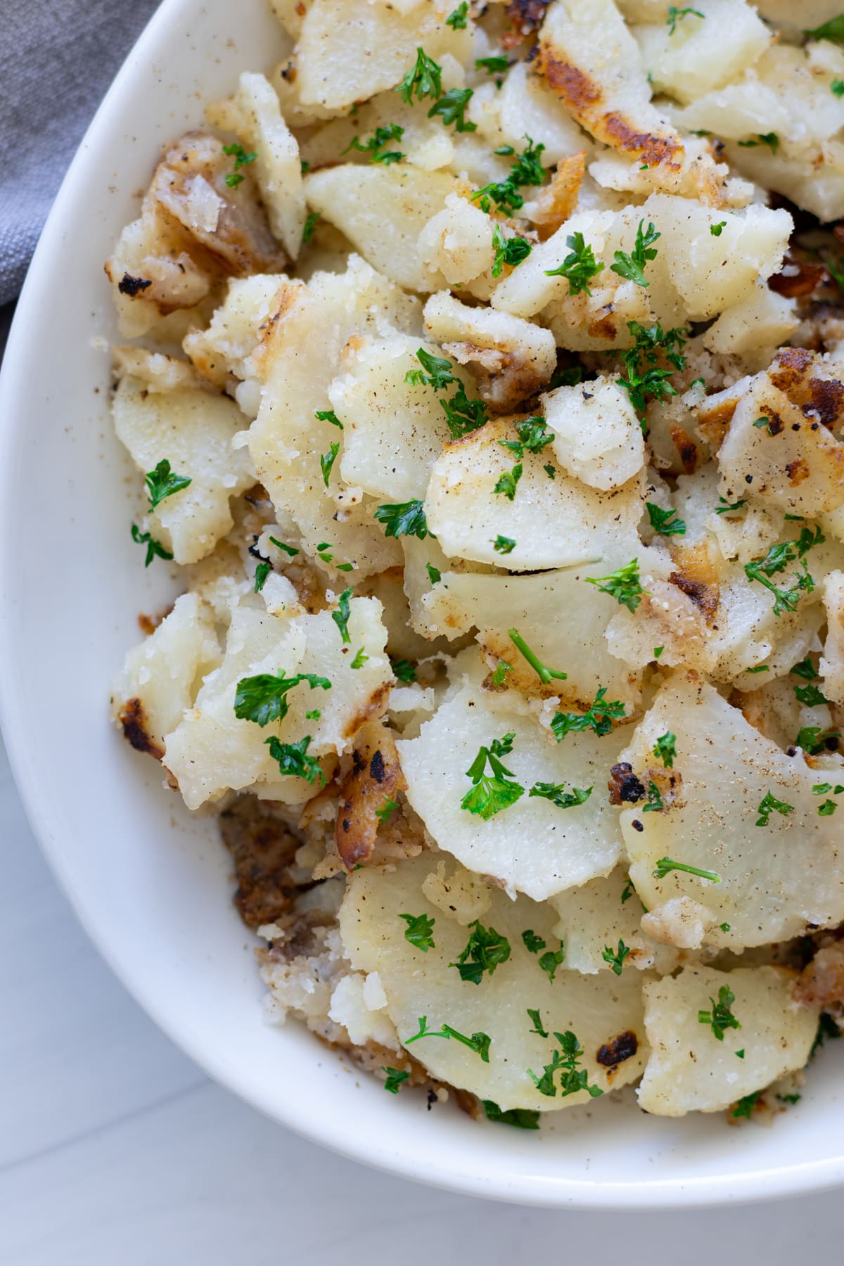 A serving platter with skillet fried potatoes. 