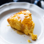 Slice of cornbread topped with honey.