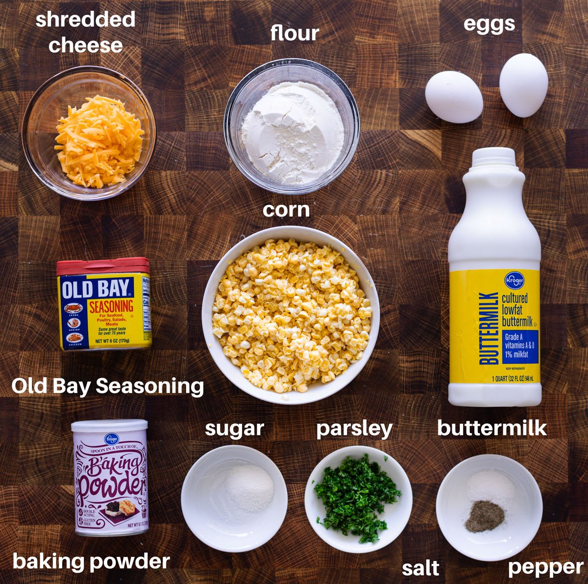 Ingredients you'll need to make Corn Fritters: Cheddar cheese, flour, eggs, buttermilk, corn, Old Bay seasoning, baking powder, sugar, parsley, salt, pepper. 