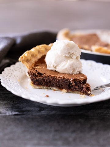 Piece of chocolate pie topped with ice cream.