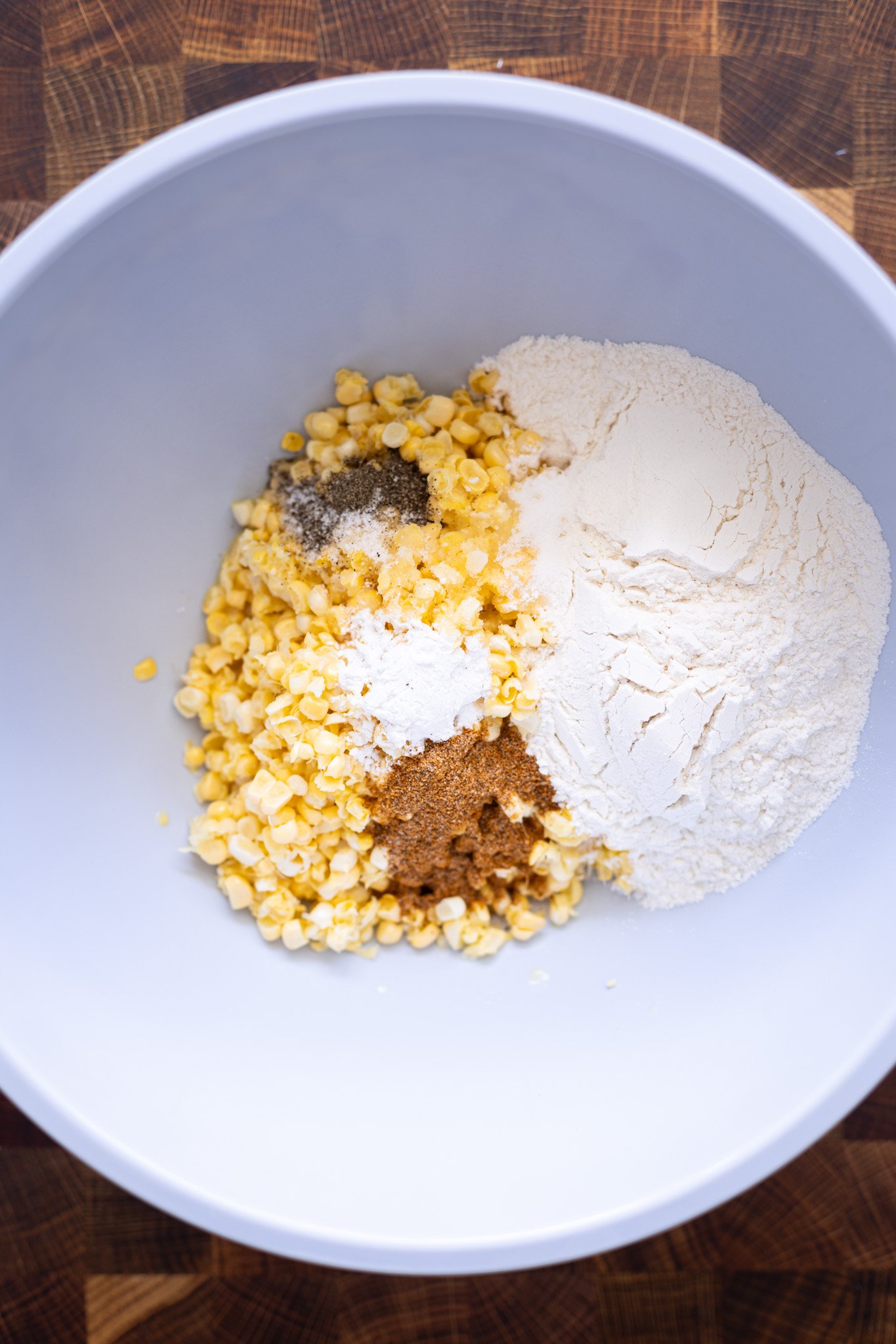 Corn, flour, seasonings in a bowl.