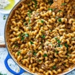 Skillet filled with homemade hamburger helper being served.