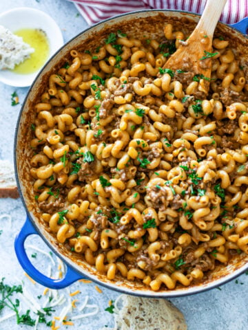 Skillet filled with homemade hamburger helper being served.