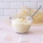 Bowl filled with cream cheese frosting on a counter.