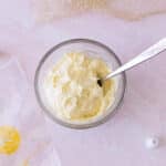 Bowl of lemon cream cheese frosting on a counter.